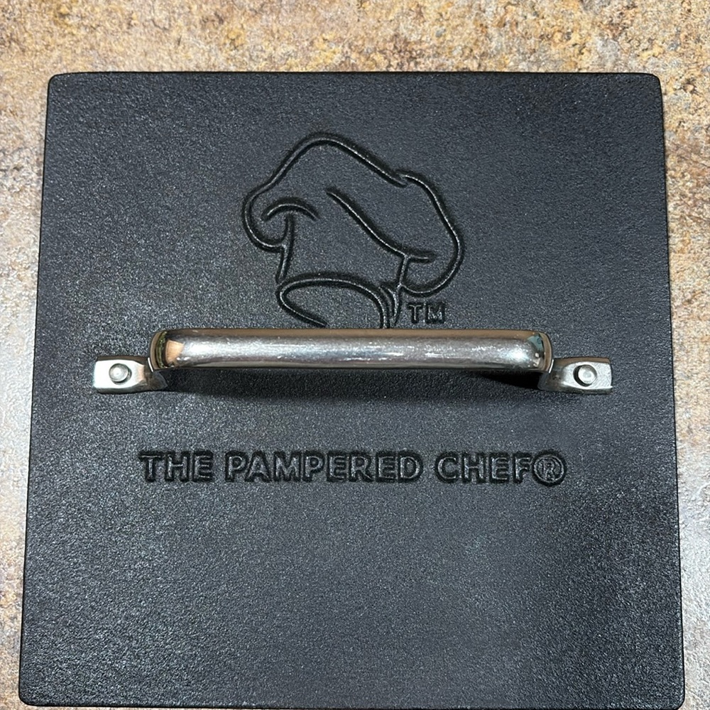 The Pampered Chef cast iron press, new w/o box.